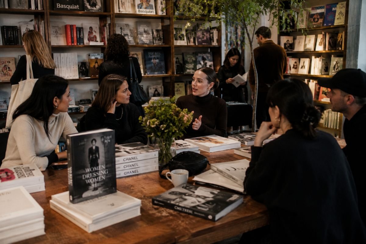 People gathering in an independent bookstore to explore fashion books and creative ideas, illustrating how fashion and independent bookstores bring communities together